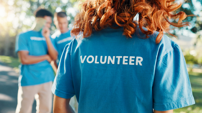 volunteer, shirt and back of woman in park for recycle program, earth day or social responsibility. environment, climate change and ngo with person in nature for non profit, cleaning or charity