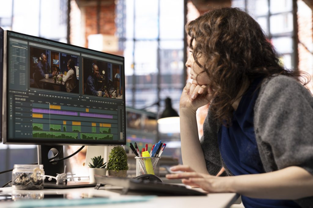 focused editor woman works on video montage in a creative software