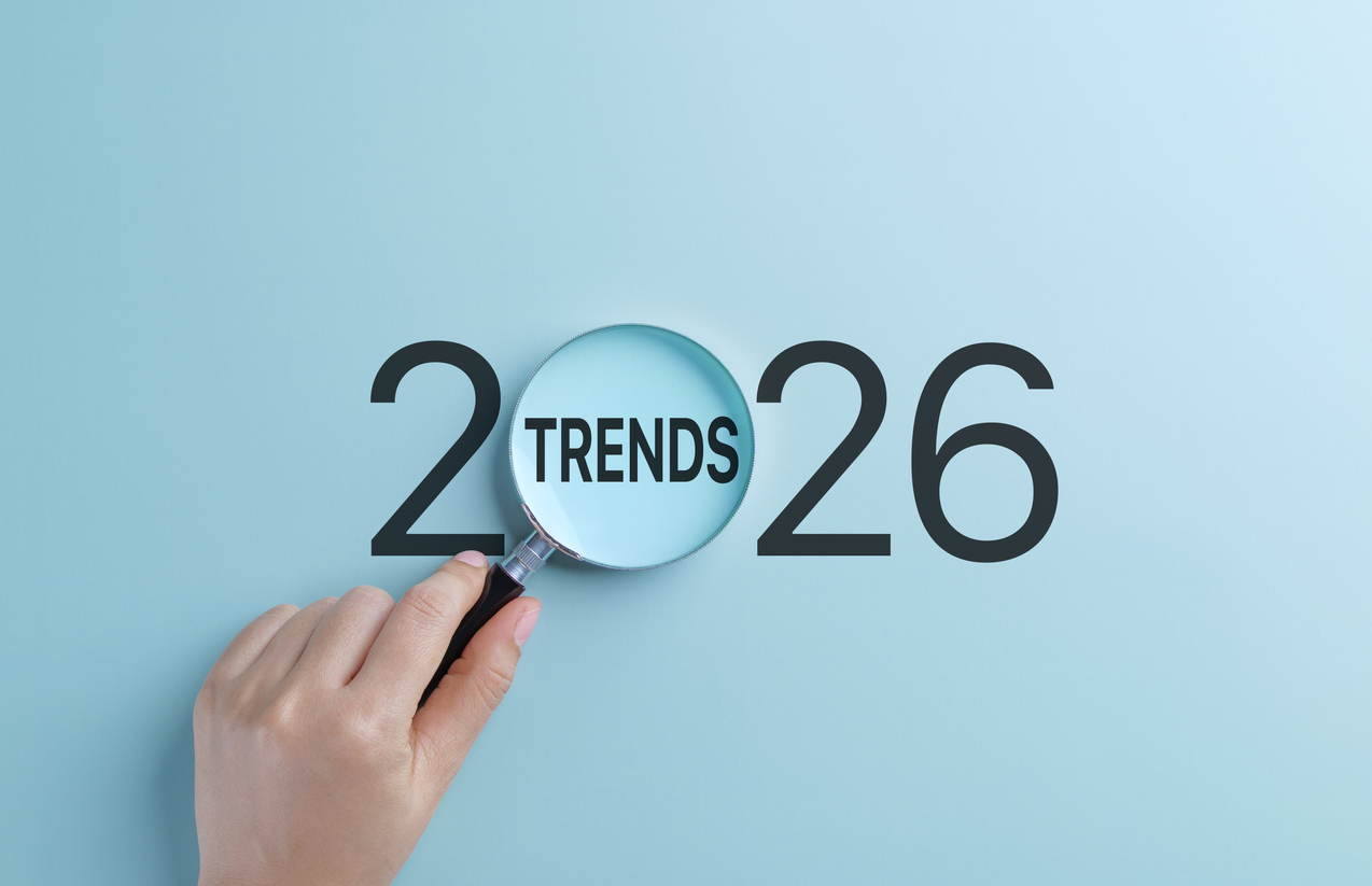2026 business trends concept. a hand holds magnifying glass focusing on the word trends within the year 2026, representing the concept of future business and marketing trends and seo planning.