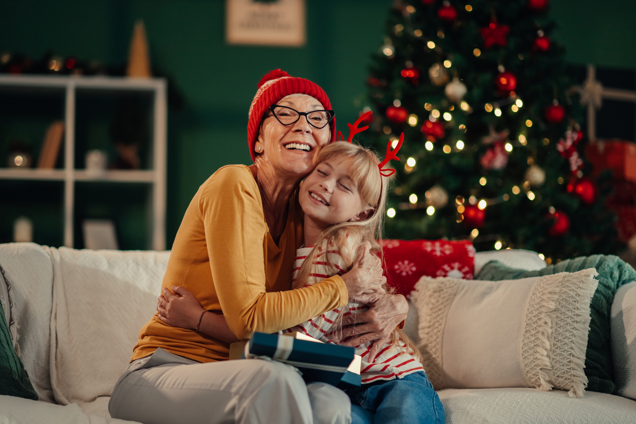 grandmother and granddaughter embracing on christmas eve