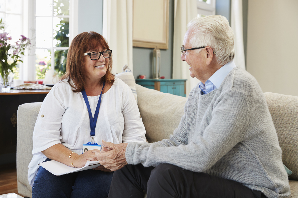 female support worker visits senior man at home