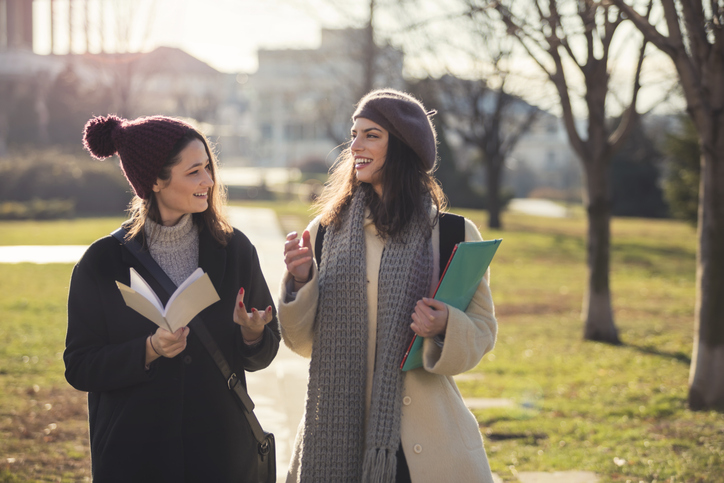 happy female students in public park