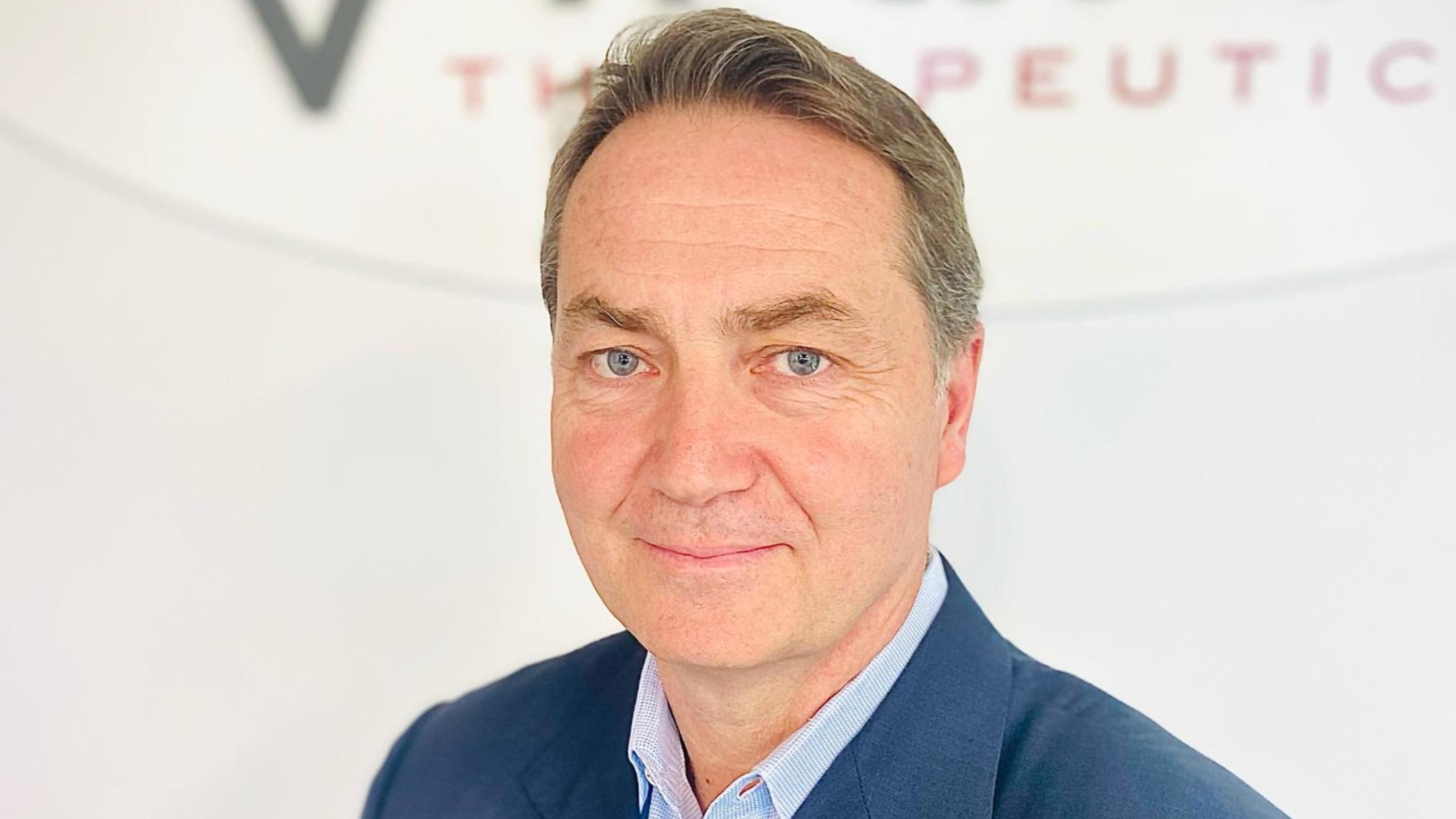 Brian Lian, Ph.D., President and CEO of Viking Therapeutics, wearing a dark suit and glasses in a professional setting.