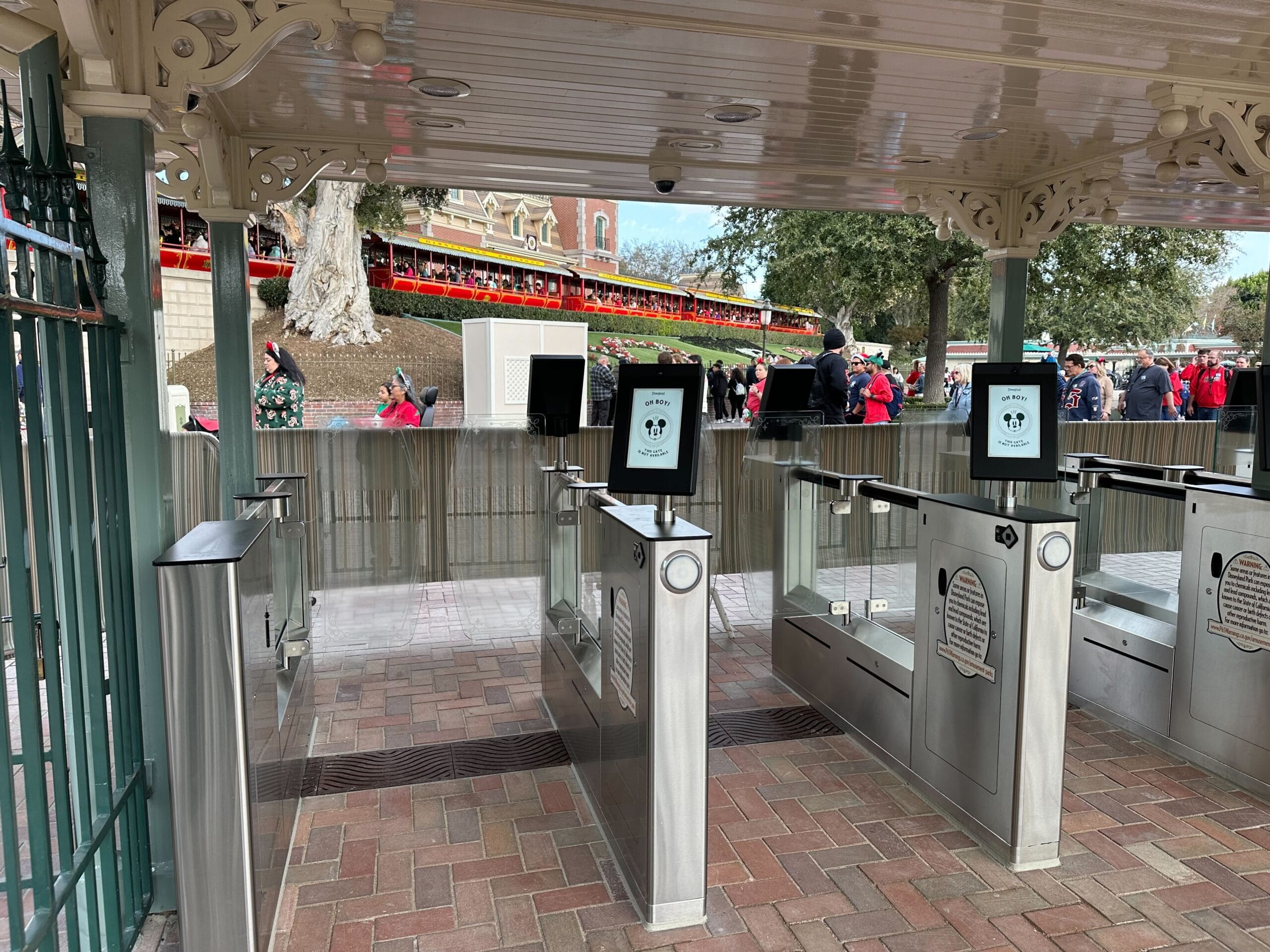 A theme park turnstile rendered with glowing digital data streams, symbolizing how entertainment platforms increasingly track and monetize consumer attention across physical and digital experiences.