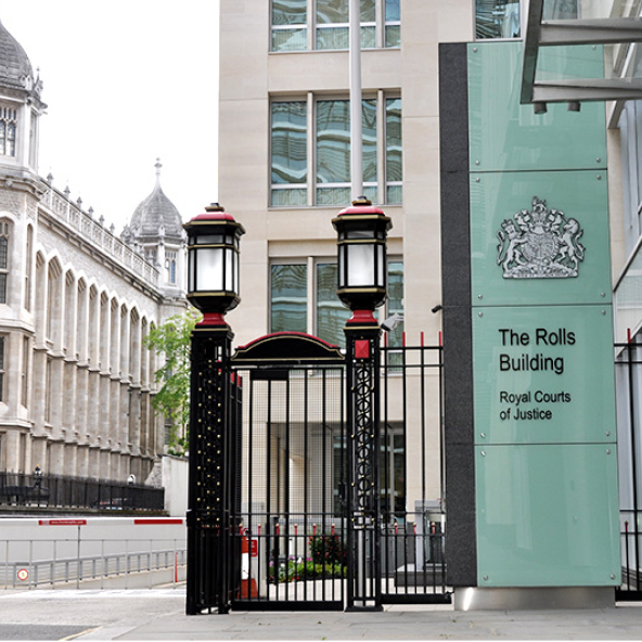 Entrance to The Rolls Building at the Royal Courts of Justice in London, showing gated access and court signage.