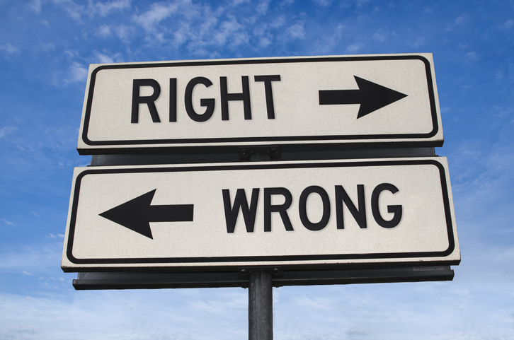right vs wrong. white two street signs with arrow on metal pole with word. directional road. crossroads road sign, two arrow. blue sky background. two way road sign with text.
