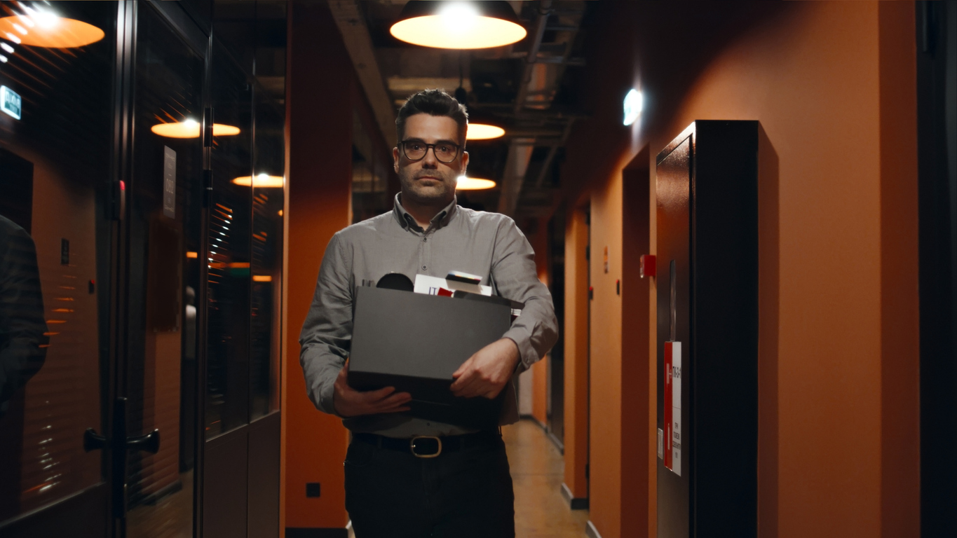 fired man saying goodbye to colleagues