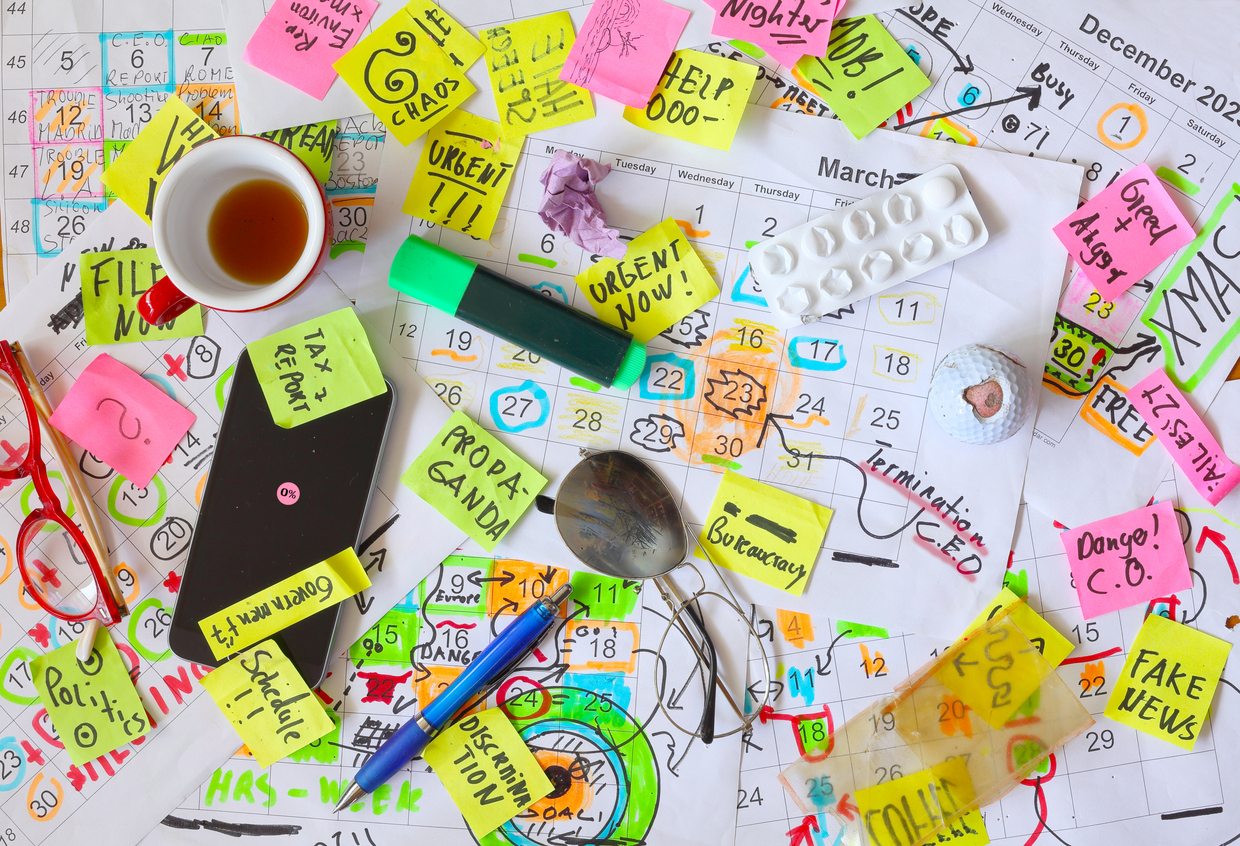 calendars with business appointments,termination notice and adhesive notes on cluttered desk. business concept,beat the clock,overwoked,bureaucracy