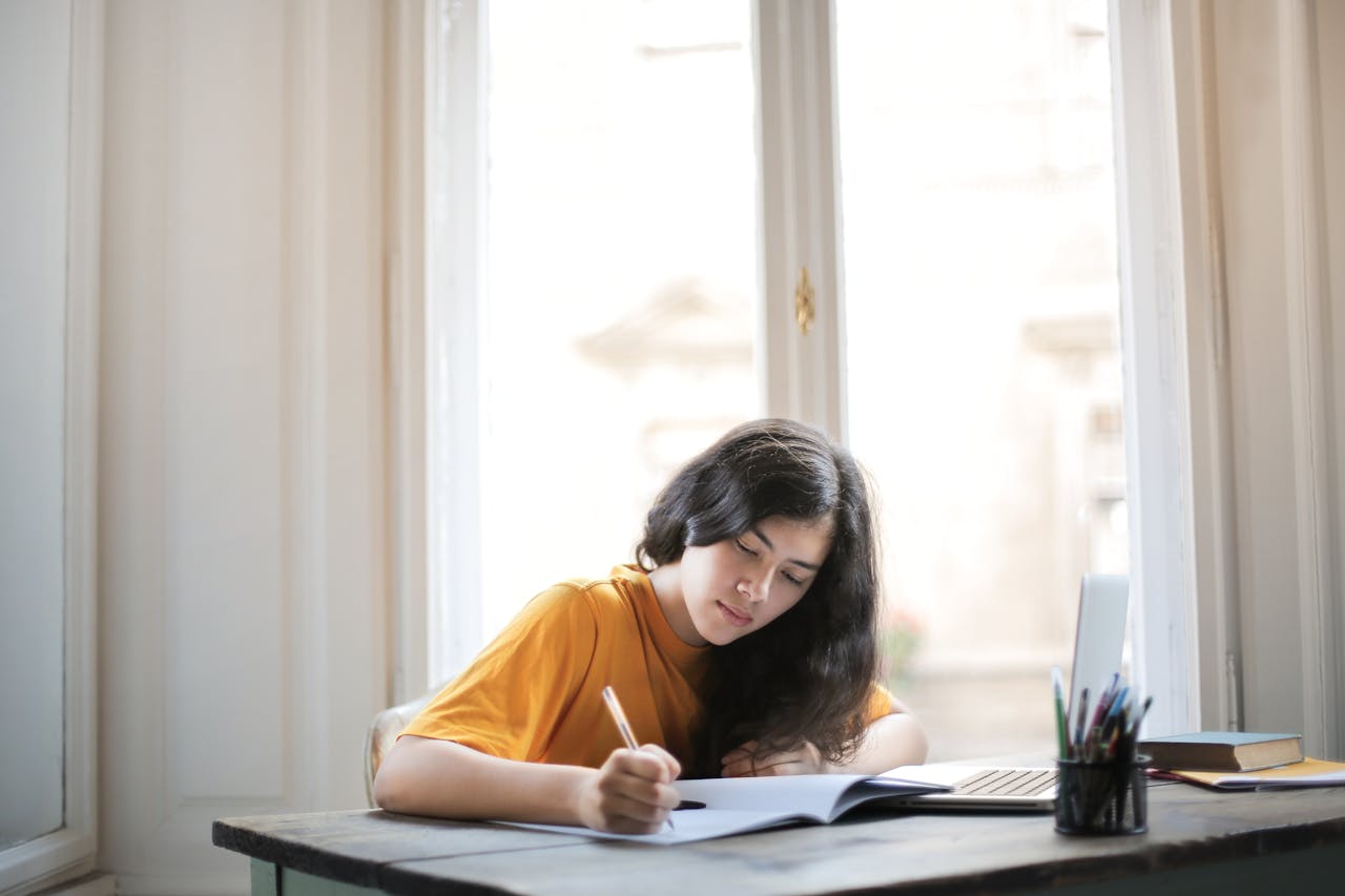 A Woman in Mustard Shirt Studying