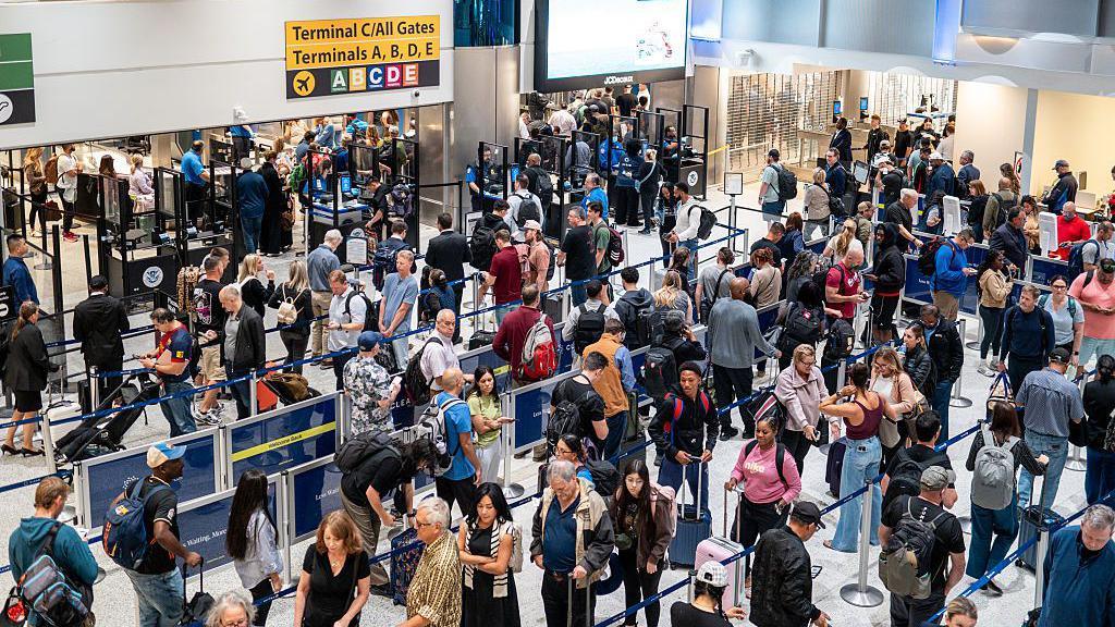 Travelers wait in line at U.S. airport security as REAL ID enforcement tightens