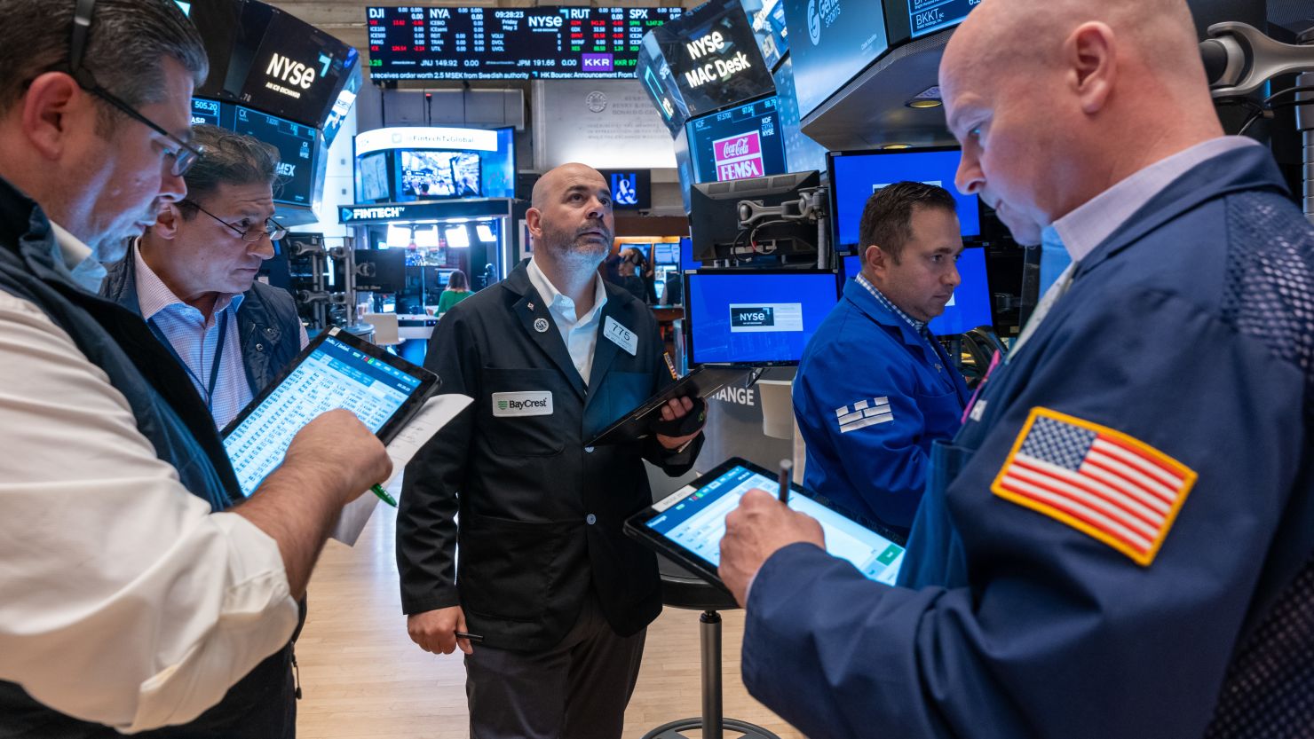 Traders work on the New York Stock Exchange floor as U.S. stock futures rise