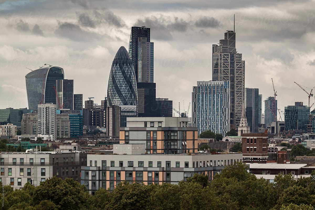 London city skyline under cloudy skies, representing economic uncertainty and business slowdown