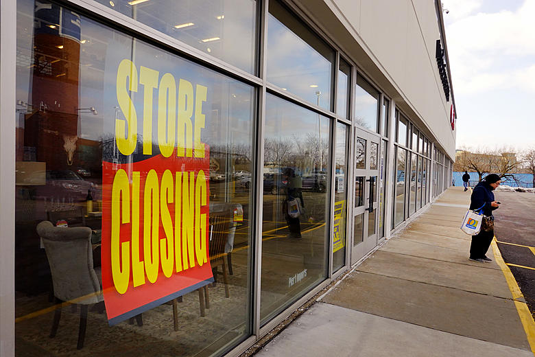 Small business storefront with &ldquo;For Sale&rdquo; sign, illustrating baby boomer retirement and succession planning risks.