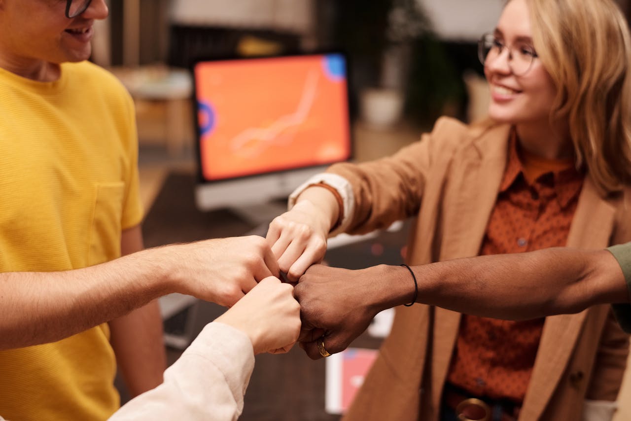Group of People Doing a Fist Bump