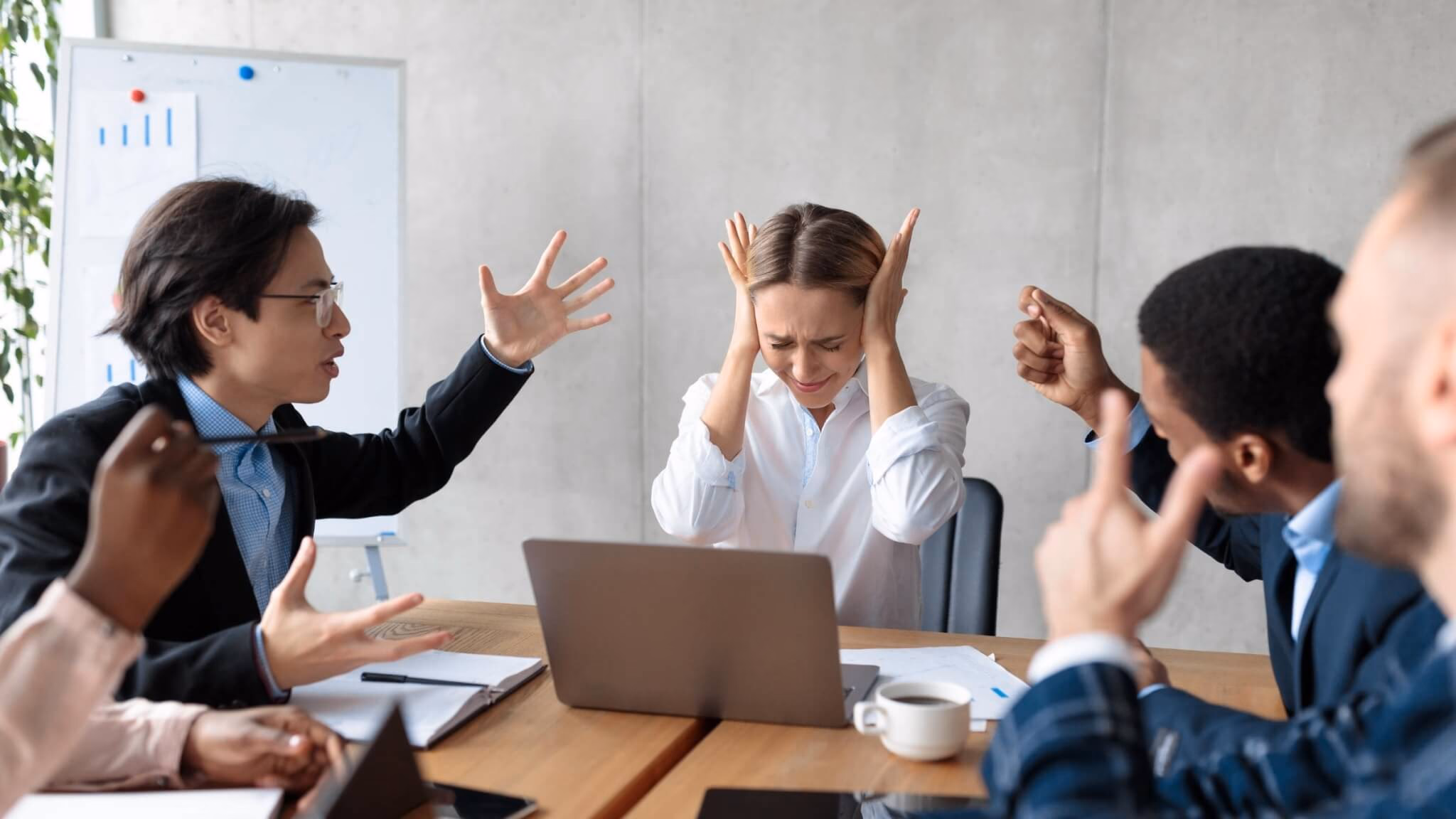 Business team in meeting showing tension and collaboration dynamics in workplace