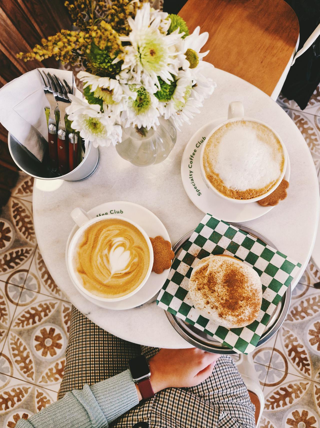 Charming Cafe Table with Coffee and Pastries